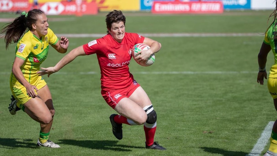 A player from Team Canada avoids a player from the opposing team.